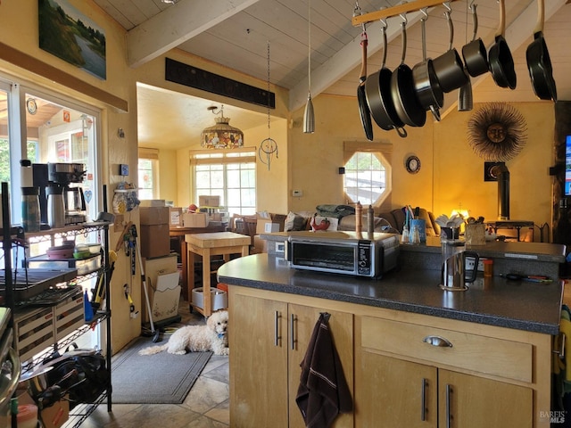 kitchen with wood ceiling, a wealth of natural light, lofted ceiling with beams, and light brown cabinets