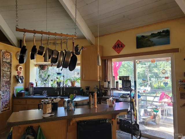 kitchen featuring sink, vaulted ceiling with beams, and wood ceiling