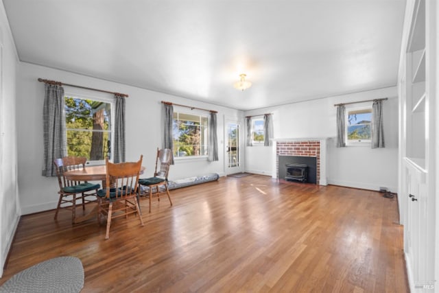 living room with wood-type flooring and a wood stove