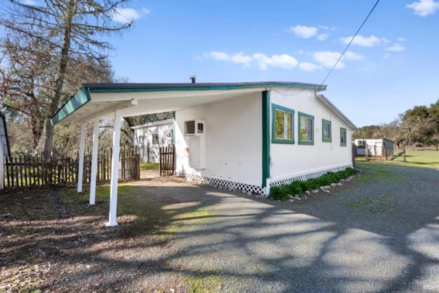 view of side of property featuring a carport