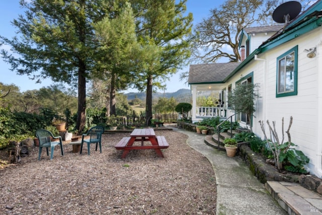 view of yard featuring a patio area and a mountain view