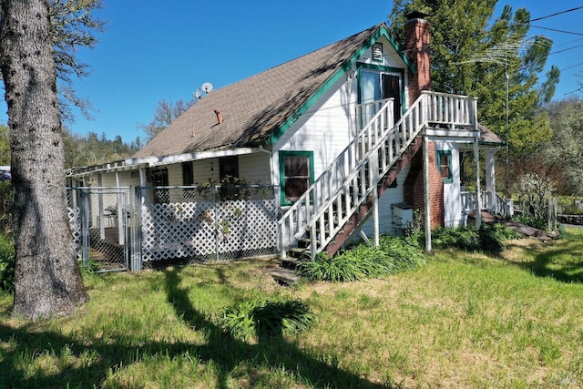 rear view of property with a yard