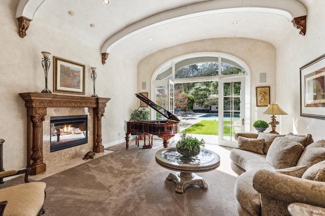 carpeted living room featuring a premium fireplace