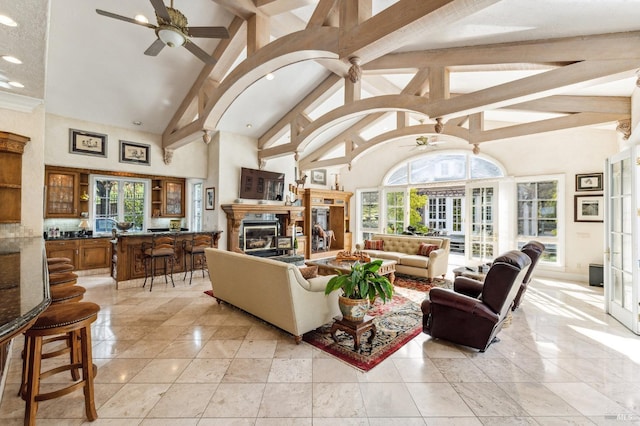 tiled living room with high vaulted ceiling, ceiling fan, beam ceiling, and a wealth of natural light