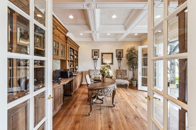 home office featuring coffered ceiling, beam ceiling, ornamental molding, french doors, and hardwood / wood-style flooring