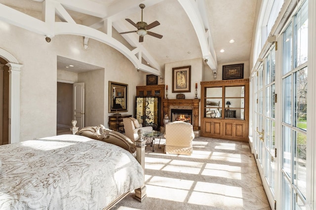 tiled bedroom with beam ceiling, high vaulted ceiling, and multiple windows