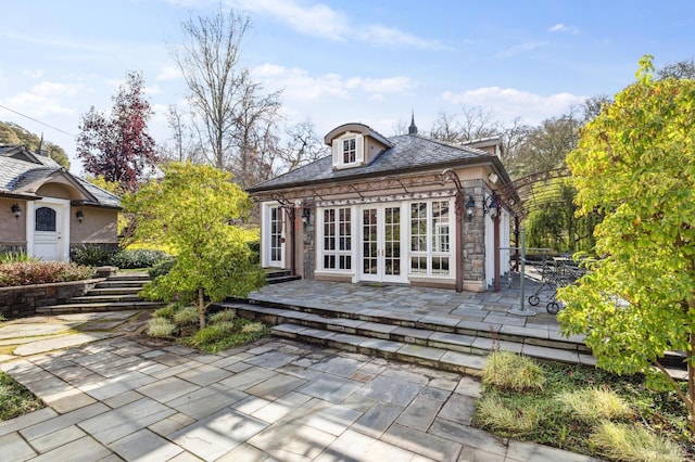 rear view of house featuring a patio area and french doors