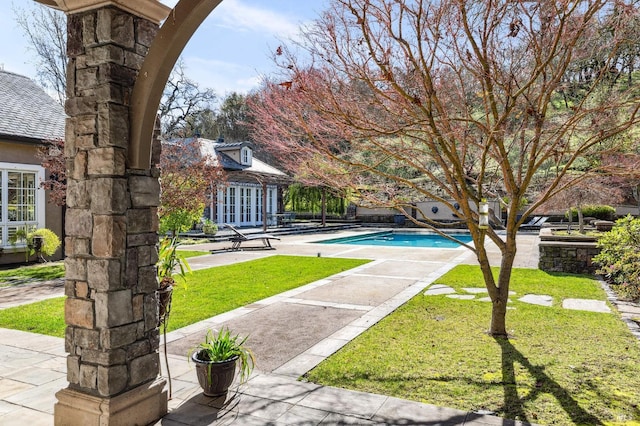 view of yard with french doors and a patio