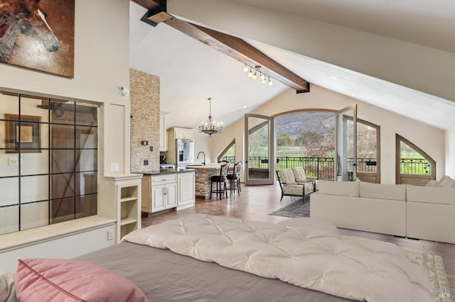 living room featuring an inviting chandelier, beam ceiling, and high vaulted ceiling