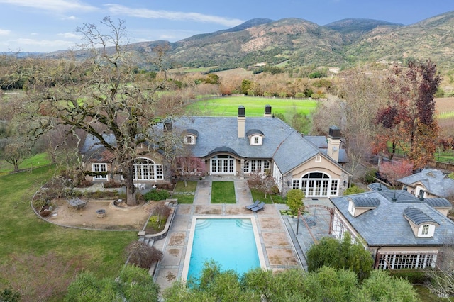 exterior space with a mountain view and a patio area