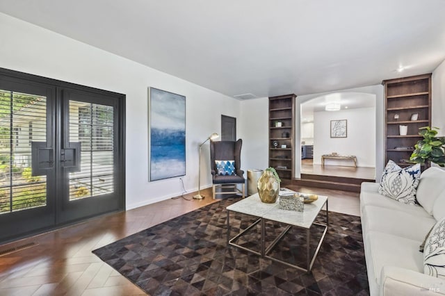 living room featuring french doors and parquet floors