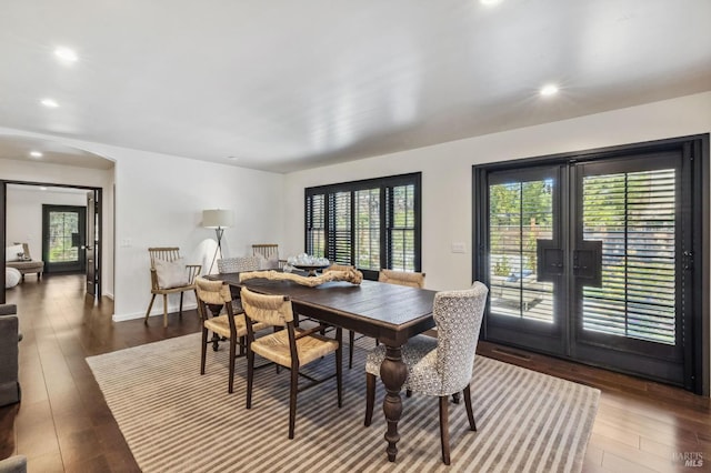 dining area with dark hardwood / wood-style flooring and french doors