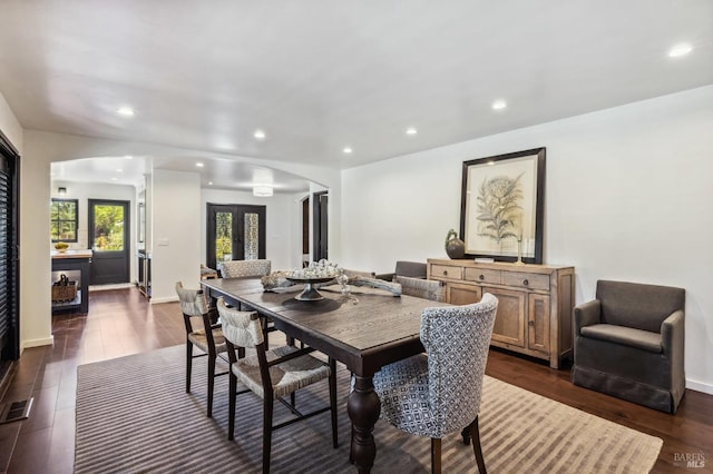 dining space featuring french doors and dark wood-type flooring