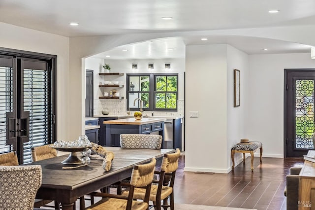 dining room with dark hardwood / wood-style floors and sink