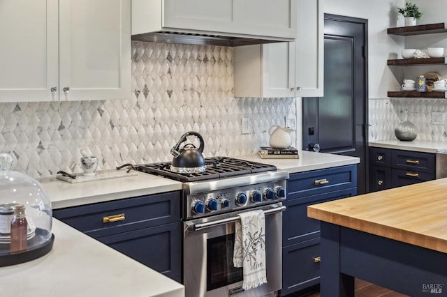 kitchen featuring blue cabinetry, white cabinetry, butcher block counters, and stainless steel stove