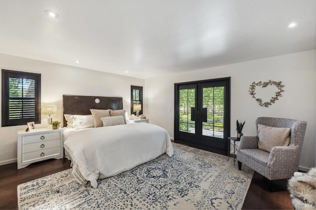 bedroom with dark hardwood / wood-style flooring, access to outside, and french doors