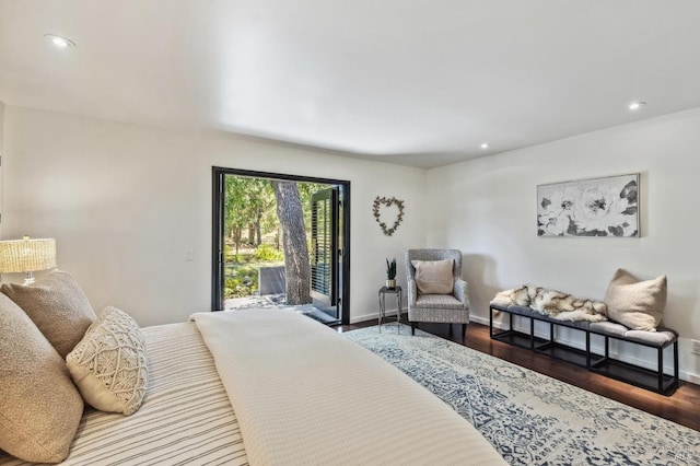 bedroom with access to exterior and hardwood / wood-style flooring