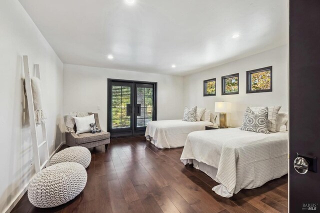 bedroom featuring access to exterior, dark wood-type flooring, and french doors