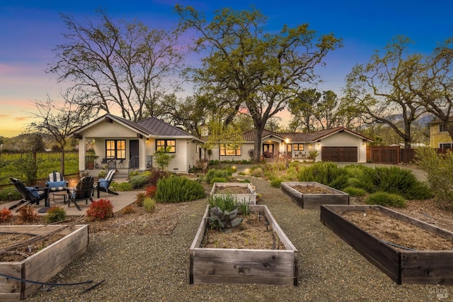 yard at dusk featuring a garage