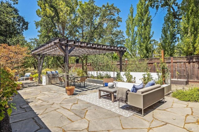 view of patio featuring an outdoor living space, exterior kitchen, and a pergola