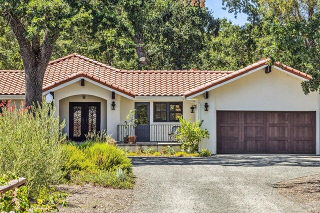 mediterranean / spanish house featuring a garage