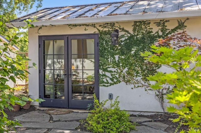 view of exterior entry featuring french doors