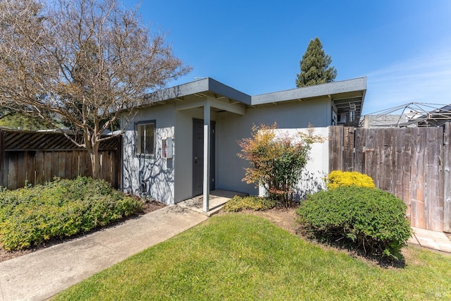 exterior space featuring an outdoor structure and a lawn