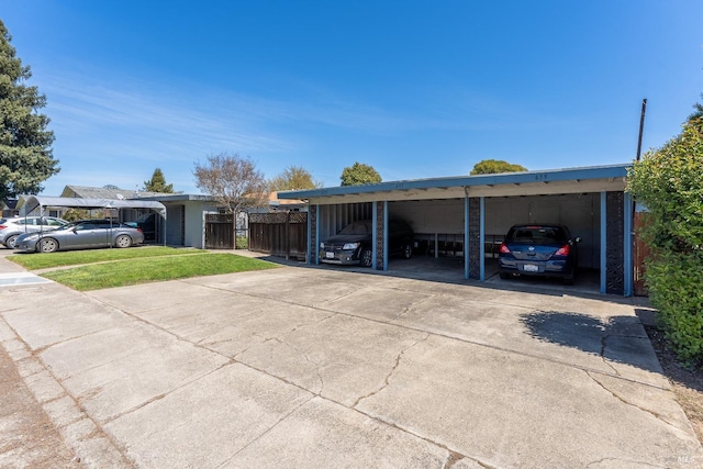 view of parking with a lawn and a carport