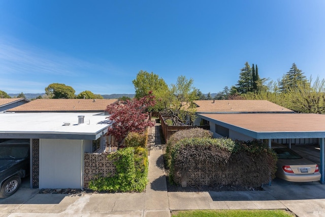 view of side of property with a carport