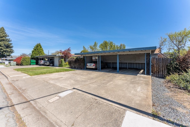 ranch-style home featuring a carport and a front yard