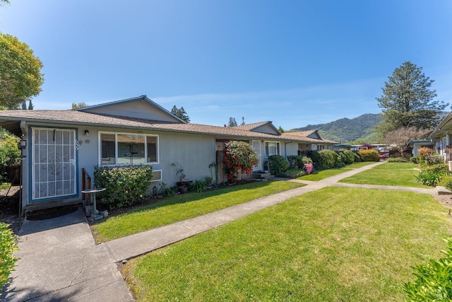 ranch-style house with a mountain view and a front yard