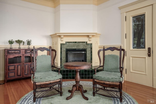 living area with ornamental molding and dark wood-type flooring