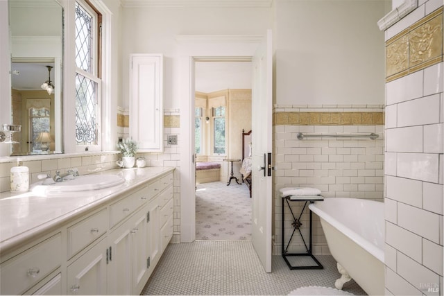 bathroom featuring vanity with extensive cabinet space, tile floors, tile walls, and a washtub