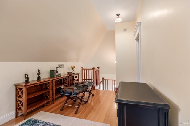 living area with light hardwood / wood-style flooring and lofted ceiling