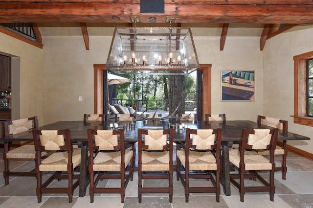 dining space with beamed ceiling and light tile flooring