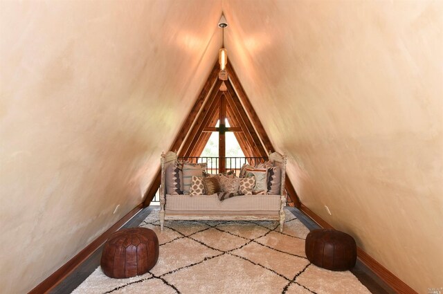 interior space with light colored carpet and lofted ceiling