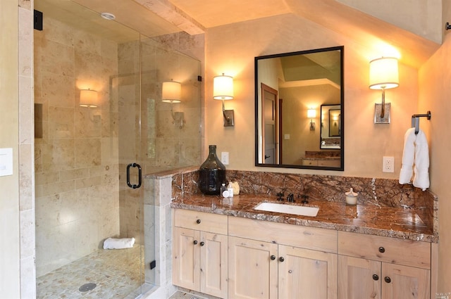 bathroom featuring vanity and a shower with shower door