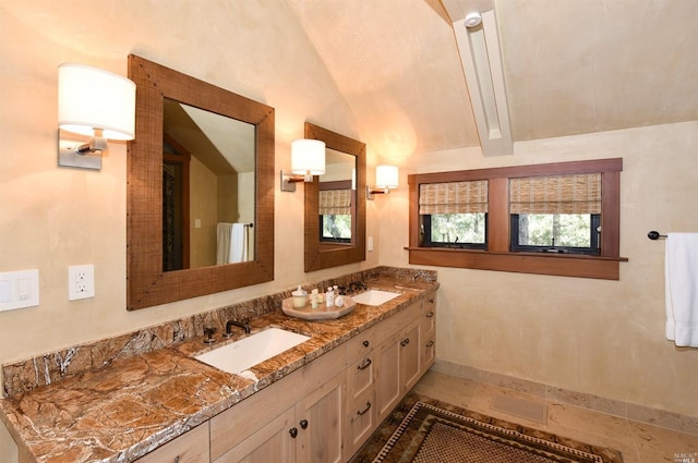 bathroom featuring double sink, oversized vanity, vaulted ceiling, and tile flooring