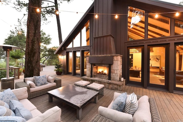 wooden terrace featuring an outdoor living space with a fireplace