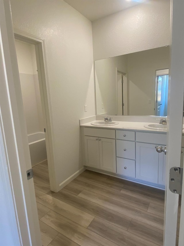 bathroom with hardwood / wood-style floors and vanity