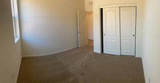 unfurnished bedroom featuring a closet and carpet