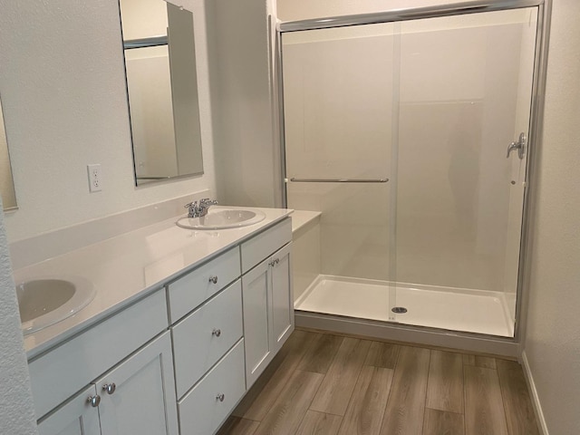 bathroom featuring vanity, hardwood / wood-style flooring, and an enclosed shower