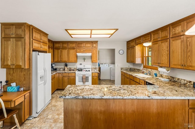 kitchen featuring white appliances, kitchen peninsula, washing machine and clothes dryer, sink, and light tile floors