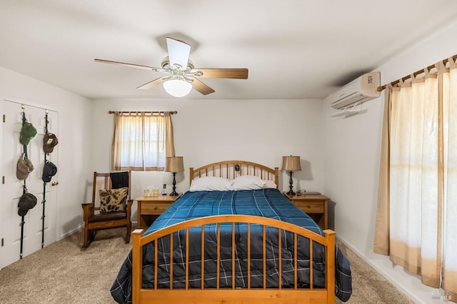 carpeted bedroom featuring an AC wall unit and ceiling fan