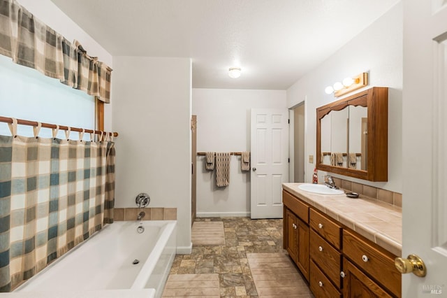 bathroom featuring tile flooring, vanity, and a washtub