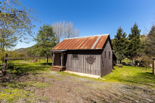 view of shed / structure featuring a rural view and a yard