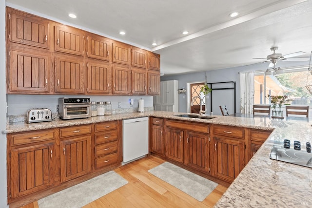 kitchen with a sink, a wealth of natural light, white dishwasher, and a toaster