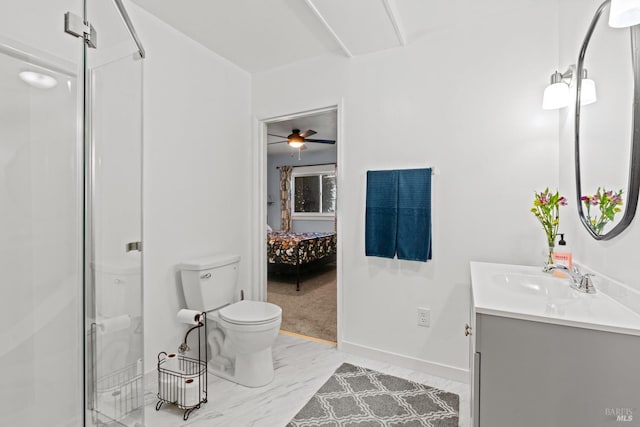 ensuite bathroom with vanity, baseboards, a stall shower, ensuite bathroom, and toilet