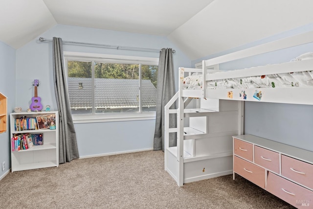 bedroom featuring baseboards, lofted ceiling, and carpet