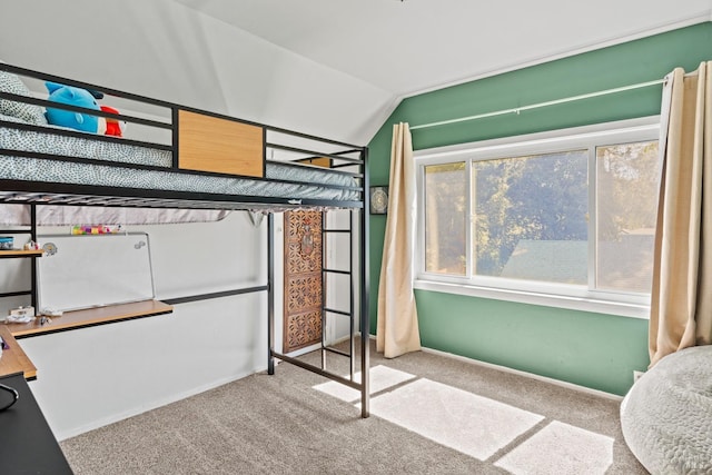 bedroom with carpet floors and vaulted ceiling